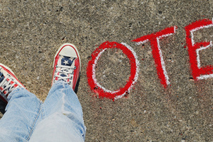 two feet forming the letter v followed by the letters O, T, and E, written in chalk.